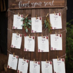 Wooden Palette Order Of The Day Sign With White Calligraphy Greenery